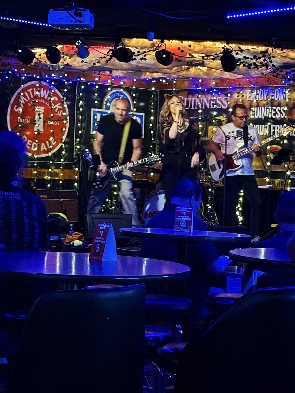 Rock Steady performing on the stage at an Irish pub under blue lights